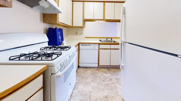 a kitchen with a stove and a refrigerator at Hampton Lakes Apartments in Walker, MI 49534