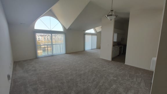 an empty living room with a large window