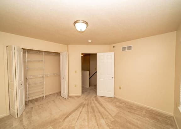 bedroom with closet with wardrobe organizers bedroom with closet with wardrobe organizers at Foxwood and The Hermitage, Portage, MI