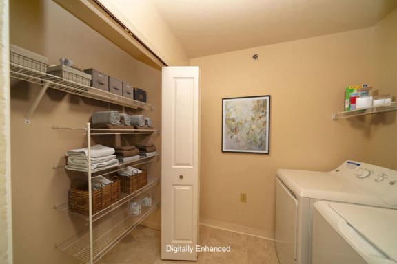 a laundry room with a washer and dryer and a closet a laundry room with a washer and dryer and a closet at Foxwood and The Hermitage, Portage, MI, 49024