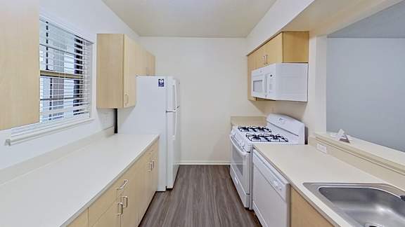 Kitchen with abundant cabinet space and a breakfast bar at Foxwood and The Hermitage, Portage, Michigan
