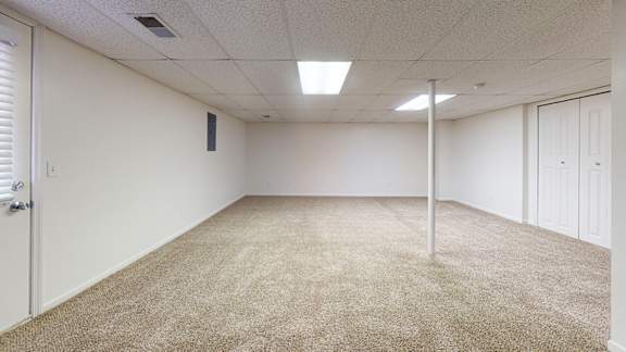 A basement with carpet and storage area at Foxwood and The Hermitage, Michigan
