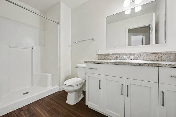 A white bathroom with a toilet, sink, and bathtub.
