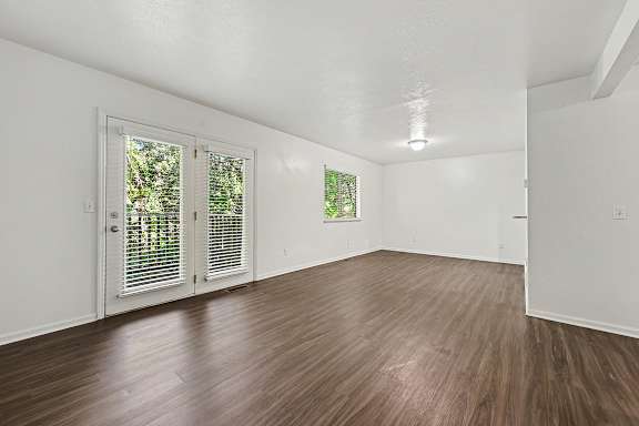 A room with wooden floors and white walls.