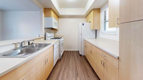A kitchen with wooden cabinets and a white appliances at Foxwood and The Hermitage, Michigan, 49024