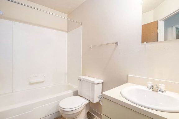 a bathroom with a sink toilet and a bath tub at Hickory Village Apartments, Mishawaka, IN, 46545
