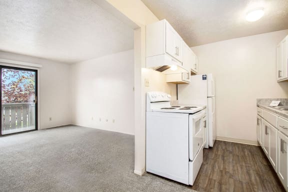 an empty kitchen with white appliances and a window at Hickory Village Apartments, Mishawaka, 46545