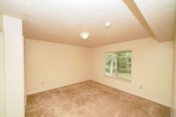 a empty living room with a large window at The Highlands Apartments, Elkhart, 46514