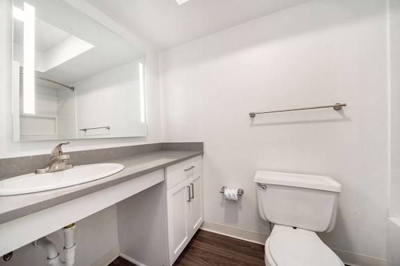 A white toilet sits next to a sink in a bathroom