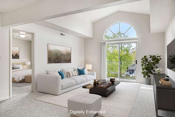 A living room with a cathedral ceiling at The Highlands Apartments in Elkhart, IN