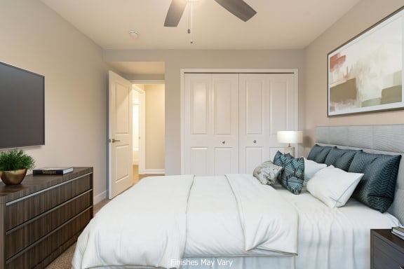 a bedroom with a large bed and a ceiling fan at Hillside Apartments, Michigan, 48393