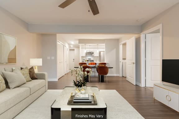 a living room with a couch and a coffee table in front of a tv at Hillside Apartments, Wixom, 48393
