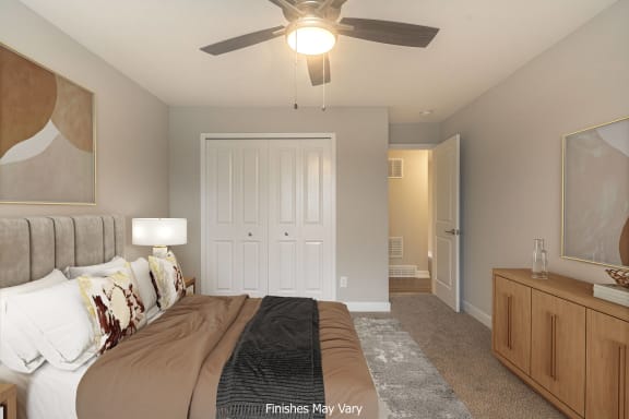 a bedroom with a large bed and a ceiling fan at Hillside Apartments, Wixom, Michigan