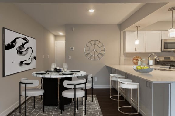 a kitchen with a large center island with a breakfast bar at Hillside Apartments, Wixom, 48393