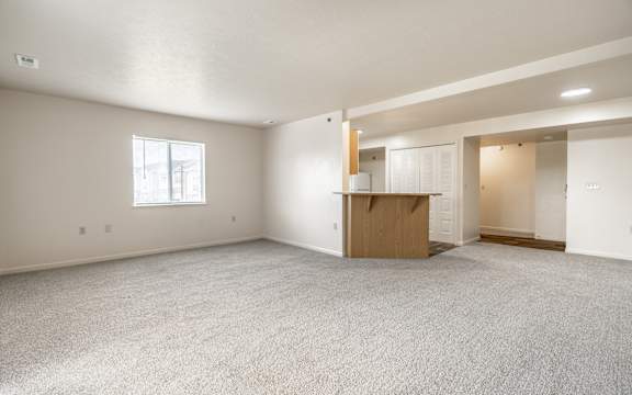 Empty room with a window and a door at Huntington Cove Apartments, Merrillville, IN