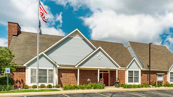 A building with a flag on top of it at Huntington Cove Apartments, Merrillville, IN