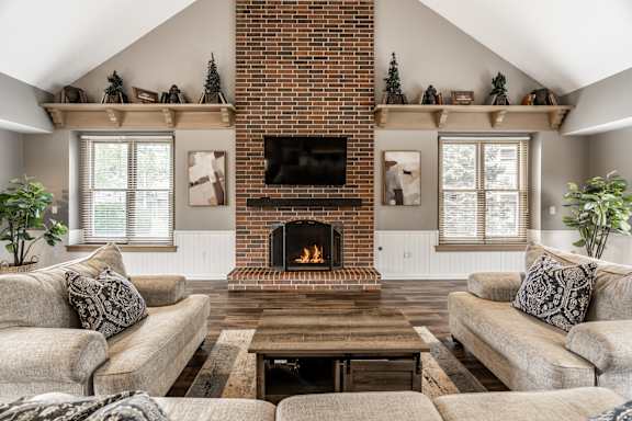 A cozy living room with a fireplace and a couch at Huntington Cove Apartments, Merrillville, IN