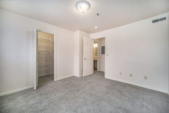 an empty bedroom with a closet and a mirrored closet door  at Hurwich Farms Apartments, South Bend, IN, 46628