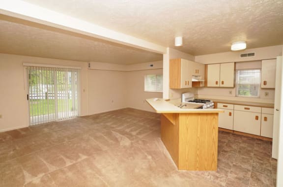 End style kitchen and living room at Hurwich Farms Apartments in South Bend, IN