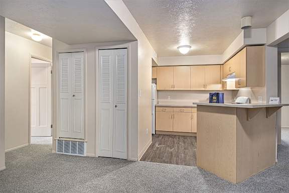 A dining room and kitchen with a breakfast bar at Indian Lakes Apartments, Mishawaka, IN