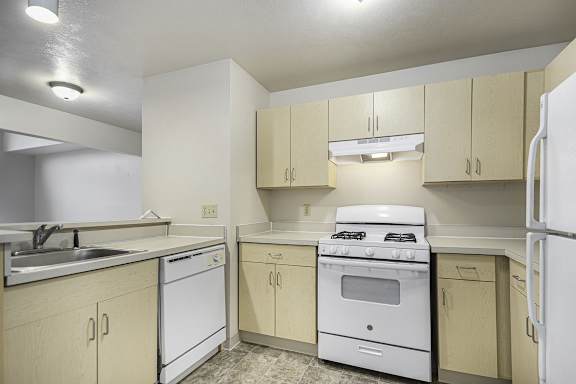 A two bedroom kitchen with white appliances at Indian Lakes Apartments, Mishawaka, IN