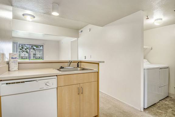 A kitchen with a white dishwasher and sink at Indian Lakes Apartments, Mishawaka, IN