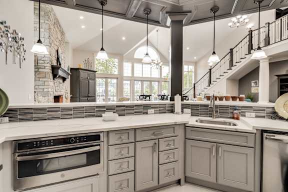 A kitchen with a stone wall and a stove top oven at Westlake Apartments, Michigan