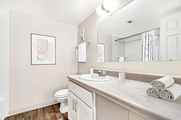 An upgraded bathroom with white cabinetry at Irish Hills Apartments, South Bend, Indiana