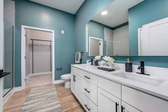 A bathroom with a white sink and a mirror above it at Ironwood Flats Apartments, Brandon, Florida