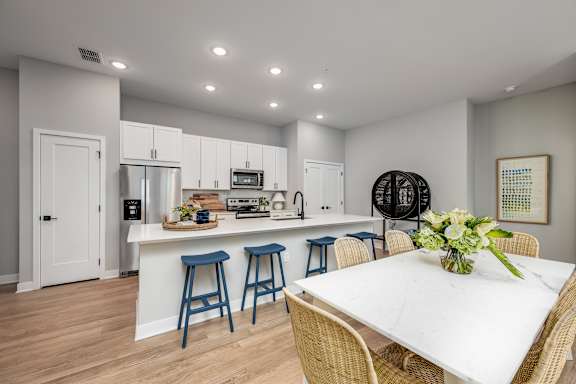 A kitchen with a bar and a dining table at Ironwood Flats Apartments, Brandon