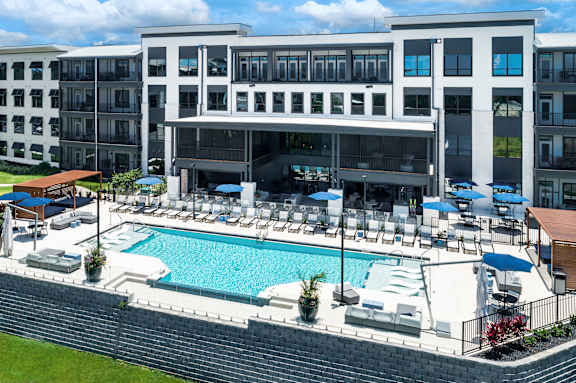 A large building with a pool in front at Ironwood Flats Apartments, Florida