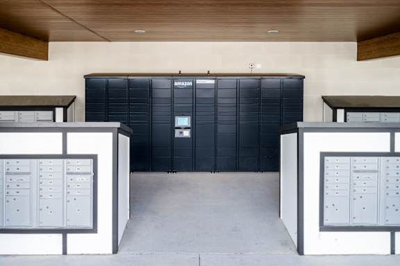 A black Amazon storage unit is in the middle of a room with two white storage units on the sides at Ironwood Flats Apartments, Brandon, Florida