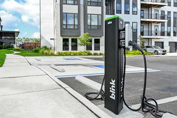 A black charging station with the word at Ironwood Flats Apartments, Brandon, 33511