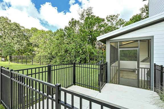 A house with a black fence and a glass door at Ironwood Flats Apartments, Florida, 33511