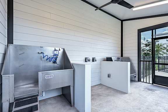 A modern kitchen with a stainless steel sink and a white countertop at Ironwood Flats Apartments, Brandon, FL, 33511
