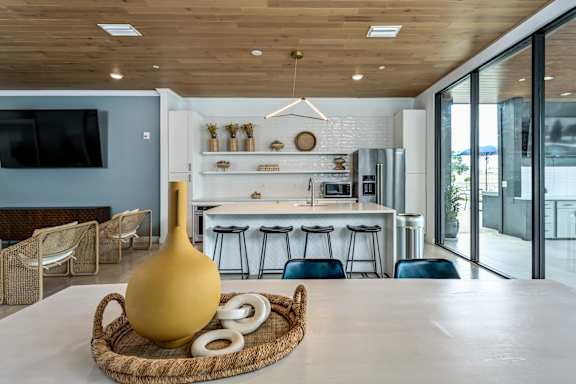 A modern kitchen with a wooden ceiling and a large yellow vase on a woven tray at Ironwood Flats Apartments, Brandon, FL
