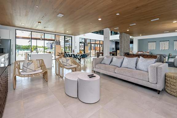 A modern living room with a wooden ceiling and a large window at Ironwood Flats Apartments, Brandon, FL, 33511