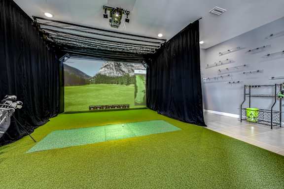 A room with a green floor and a black curtain on the side at Ironwood Flats Apartments, Brandon
