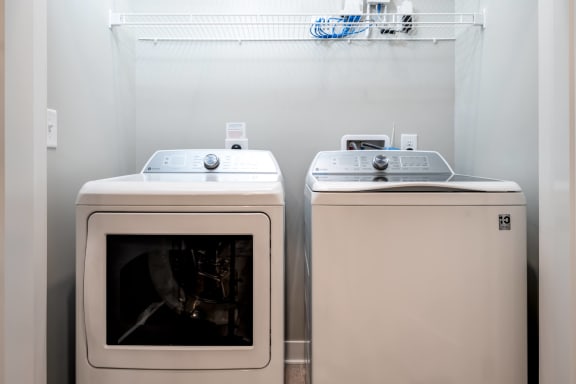 a washer and dryer sit next to each other in a laundry room  at Ironwood Flats, Florida, 33511