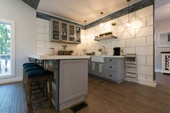 A kitchen with a bar area and a window