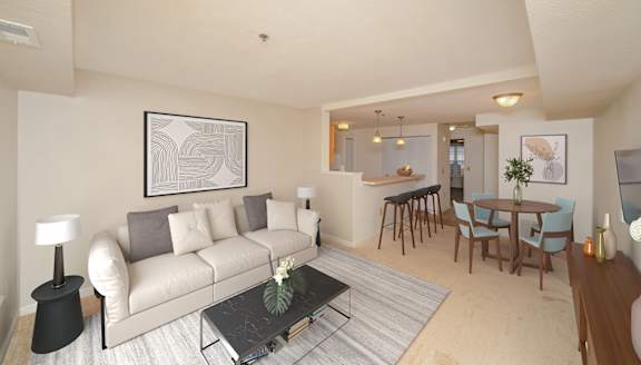 a living room and dining room with a couch and a table at Limestone Creek Apartment Homes, Alabama