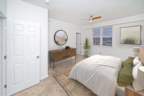 a large bedroom with a bed and a ceiling fan at Limestone Creek Apartment Homes, Madison, AL