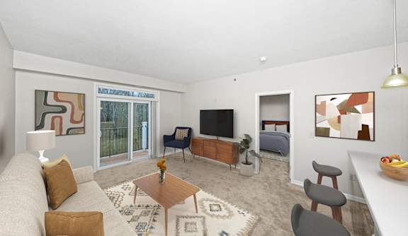 a living room with a 9 foot ceiling, couch and a tv at Limestone Creek Apartment Homes, Madison, AL