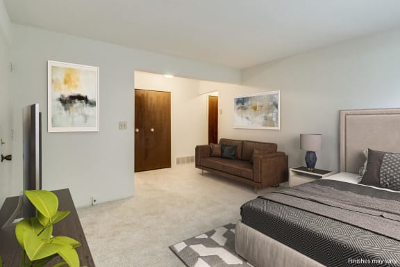 a bedroom with a couch and a bed  at Sycamore Creek Apartments, Lake Orion