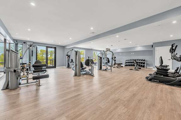 A spacious gym with a variety of equipment at Luxe 360 on Centerpointe Apartments, Virginia, 23114