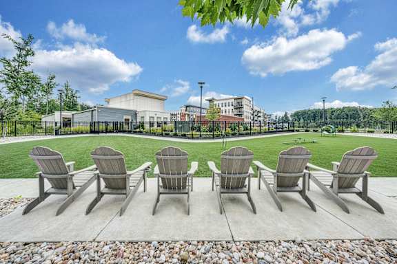 A row of chairs are lined up on a patio