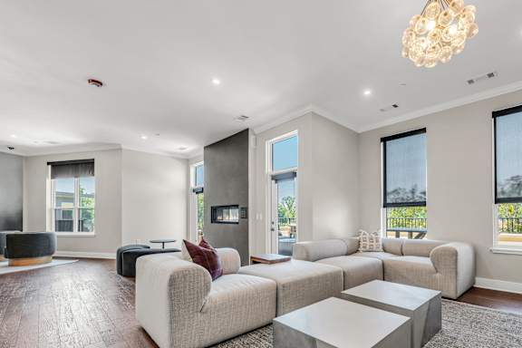A modern living room with a large sectional sofa and a coffee table at Luxe 360 on Centerpointe Apartments, Midlothian, VA, 23114