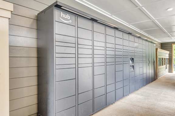 A long row of Amazon storage units are lined up in a hallway