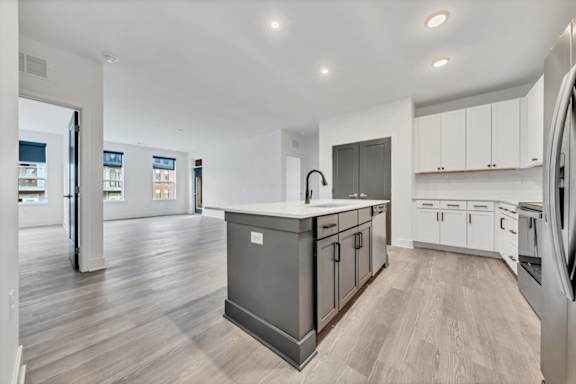 A modern kitchen with a large island and stainless steel appliances at Luxe 360 on Centerpointe Apartments, Midlothian, VA