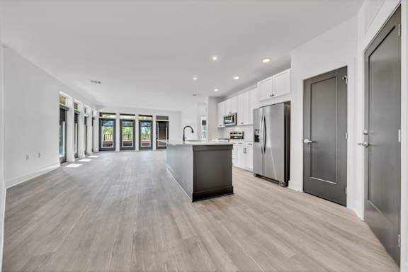 A modern kitchen with a large island and stainless steel appliances at Luxe 360 on Centerpointe Apartments, Midlothian, VA, 23114